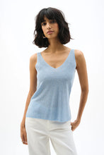 Load image into Gallery viewer, Woman wearing a light blue sequin sleeveless top and white pants on a white background.
