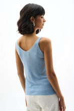 Load image into Gallery viewer, Woman wearing a light blue tank top and white pants on a white background.
