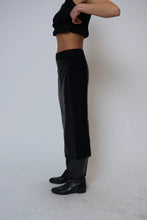 Load image into Gallery viewer, Person wearing black long skirt and black boots against a white background.
