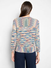 Load image into Gallery viewer, Woman wearing a colorful patterned long-sleeve sweater and navy pants against a white background.
