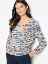 Load image into Gallery viewer, Woman wearing a colorful patterned long-sleeve sweater and navy pants against a white background.
