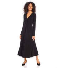 Load image into Gallery viewer, Woman wearing a black twist front midi dress and black heels on a white background.
