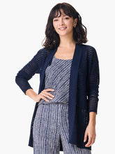 Load image into Gallery viewer, A striking, feminine cardigan full of head-turning details, this is the simple yet striking cardigan every closet needs. We love the dropped shoulder silhouette, the open front, and the knit in mesh texture and rib details along the side seam. Made from our fan-favorite Vital yarn in a deep indigo with just a little bit of cream mixed into the yarn to add some depth. Mindfully Made from cotton sourced from the largest cotton sustainability program in the world.
