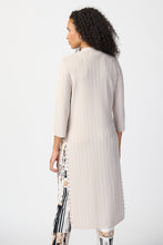 Load image into Gallery viewer, This stylish cover-up/cardigan features extended side openings and flared sleeves that impart a sense of fluidity and grace while in motion. The decorative studs along the openings add a touch of bold sophistication, making it perfect for both professional and casual settings.  Color- Moonstone. Drape silhouette. No pockets. No zipper. Not lined. Side splits lined with silver hardware.
