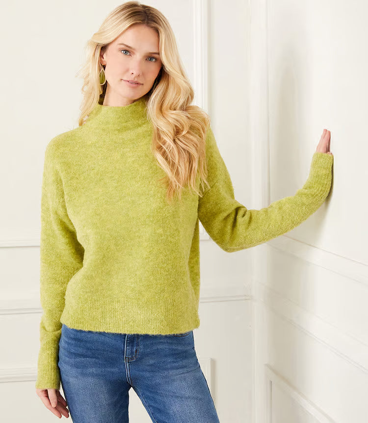 The mock neck sweater in a beautiful moss color is crafted from a soft and cozy boucle fabric that adds a touch of texture to your outfit. Its classic design is perfect for staying warm and stylish during colder months.