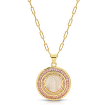 Load image into Gallery viewer, Gold necklace with a circular pendant featuring a central stone and pink gemstones on a white background.
