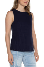 Load image into Gallery viewer, Woman wearing a navy sleeveless ribbed tank and blue jeans against a white background.
