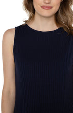 Load image into Gallery viewer, Close-up of woman wearing a sleeveless navy ribbed tank against a white background.
