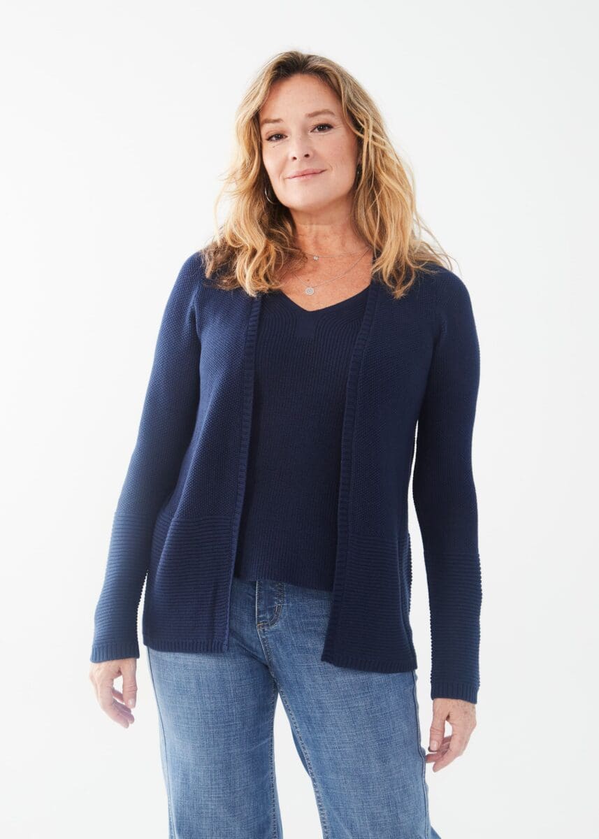 Enhance your outfit with the addition of this navy textured cardigan. Its versatile style and color make it a perfect complement to a variety of tops, whether dressed up with white pants or worn casually with denim. A must-have piece for any wardrobe.  Color- Navy. Open front. Long sleeves. Ribbed cuffs at hem.