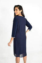 Load image into Gallery viewer, This beautiful V-neck dress comes in a luxurious navy shade with sparkling rhinestone trim along the front neckline and sleeves. The elegant chiffon split in the front offers a flowing look ideal for any special occasion. An absolute timeless classic. Color -Midnight blue with clear crystals. V-Neck. Chiffon overlay. Split fabrication in front. Crystal detailing at neckline and cuffs. Long sleeve. Knit/Woven Dress Fabric -95% Polyester. 5% Elasthane.
