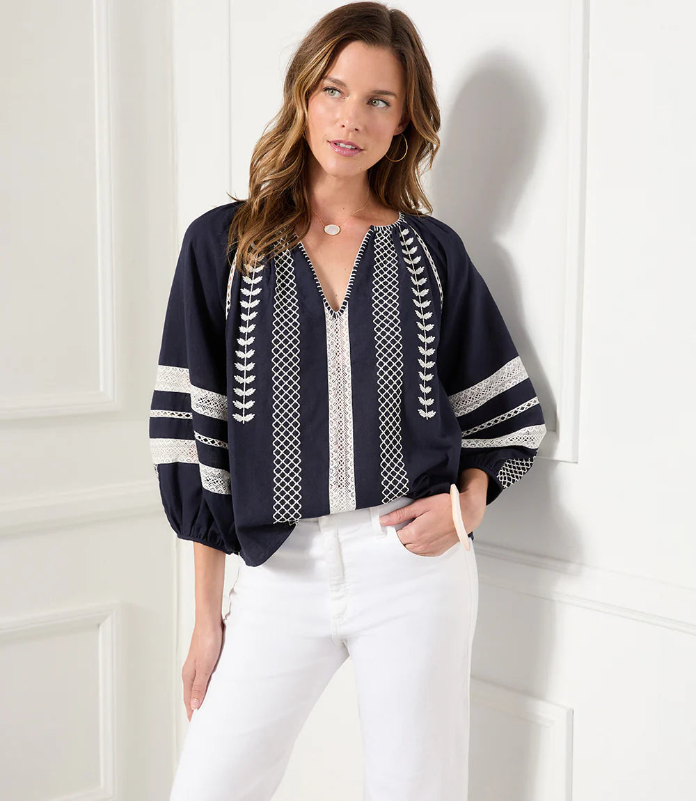 Lightweight cotton gives a breezy quality to this peasant top detailed with charming embroidery. This breezy top pairs perfectly with white pants for a fresh beachy look. Comes in both regular and plus sizes. Colors- Navy and white. Blouson sleeve V-neck Embroidered.