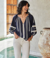 Load image into Gallery viewer, Lightweight cotton gives a breezy quality to this peasant top detailed with charming embroidery. This breezy top pairs perfectly with white pants for a fresh beachy look. Comes in both regular and plus sizes. Colors- Navy and white. Blouson sleeve V-neck Embroidered.
