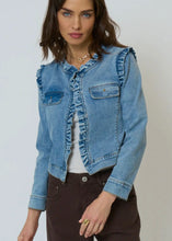 Load image into Gallery viewer, Woman wearing a denim jacket with ruffle trim over a white top and brown pants against a plain background.
