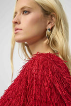 Load image into Gallery viewer, Close-up of a model wearing a red fringe top and silver earrings against a plain background.
