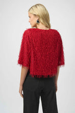 Load image into Gallery viewer, Woman wearing a red fringe sweater, black sparkle pants and black heels against a white background.
