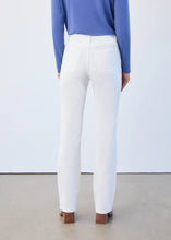 Load image into Gallery viewer, Model wearing creme colored corduroy denim pants, blue top and tan boots against a white wall.

