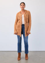 Load image into Gallery viewer, Woman wearing a brown fringed cardigan, white top, blue jeans, and brown boots against a white background.
