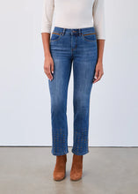 Load image into Gallery viewer, Model wearing a white top, blue bootcut jean with brown trim and metallic rivets at the hems and brown suede boots against a white background.
