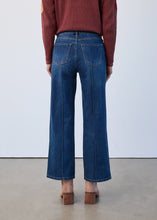 Load image into Gallery viewer, Model wearing a burgundy sweater, dark indigo jeans and tan suede boots against a white background.
