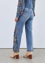 Load image into Gallery viewer, Woman in denim shacket with floral sleeves, jeans with floral side inserts and tan boots against a white background.
