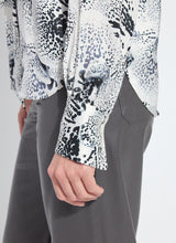 Load image into Gallery viewer, Close-up of a model wearing a patterned shirt with rhinestones and grey pants against a white background.
