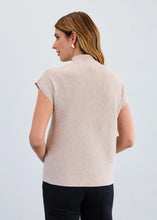 Load image into Gallery viewer, Woman wearing a beige cap sleeve sweater and black pants against a white background.
