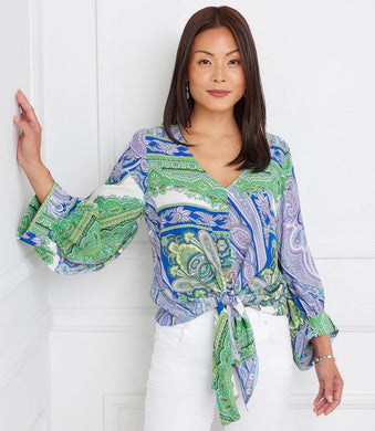 Featuring a captivating green and blue paisley print, this top effortlessly commands attention with its vibrant hues and eye-catching design. Designed with blouson sleeves and a tie-front detail, this top offers a relaxed yet chic silhouette that drapes beautifully on the body with a customizable fit.