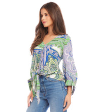 Load image into Gallery viewer, Featuring a captivating green and blue paisley print, this top effortlessly commands attention with its vibrant hues and eye-catching design. Designed with blouson sleeves and a tie-front detail, this top offers a relaxed yet chic silhouette that drapes beautifully on the body with a customizable fit.
