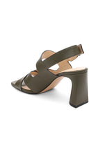 Load image into Gallery viewer, This heeled sandal in a gorgeous olive boasts a retro look, complete with inked edge details and a subtle icon buckle. Elevate any outfit with a touch of elegance.
