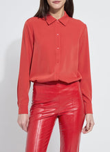 Load image into Gallery viewer, Model wearing a red blouse and red pants against a white background.
