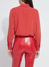Load image into Gallery viewer, Model wearing a red blouse and red pants against a white background.

