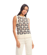 Load image into Gallery viewer, Woman wearing a sleeveless floral-patterned crochet top and cream pants against a white background.
