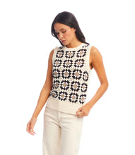 Load image into Gallery viewer, Woman wearing a sleeveless floral-patterned crochet top and cream pants against a white background.
