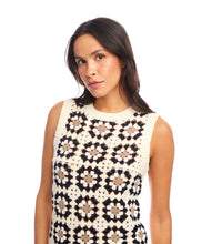 Load image into Gallery viewer, Woman wearing a sleeveless floral-patterned crochet top and cream pants against a white background.
