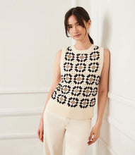 Load image into Gallery viewer, Woman wearing a sleeveless floral patterned crochet top against a white background.
