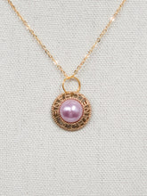 Load image into Gallery viewer, A stunning pink pearl glistens in a gold setting with the words CHANEL and the CC logo surrounding the pearl in a circle.  A sweet addition to your jewelry collection, this gorgeous piece is rare and unique. This necklace is an attention grabber!  Color- Pink and gold. Vintage Coco Chanel button. Pendant length with bale- 1 inch. 18-inch diamond cut flat gold chain. Lobster clasp. Composition- 16k gold plating over brass. Handmade re-purposed jewelry.
