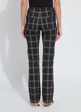Load image into Gallery viewer, Model wearing black and off-white plaid pants and black flats standing against a white background.
