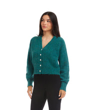 Load image into Gallery viewer, Woman wearing a teal cardigan with pearl buttons and black pants against a white background.
