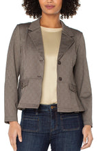 Load image into Gallery viewer, Woman wearing a brown pinstripe blazer over a beige top and blue jeans against a white background.

