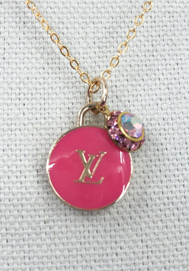 With its delicate and attention-grabbing design, the Permelia Pink Vintage Louis Vuitton Zipper Pull and Iridescent Charm Necklace is a one-of-a-kind piece that reflects your individuality. Its playful and flirtatious nature is sure to elevate any ensemble.