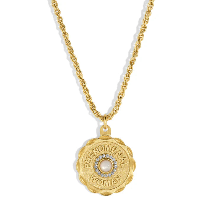 Gold necklace with a pendant that has a white pearl surrounded by crystal and reads 'PHENOMENAL WOMAN' against a white background.