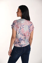 Load image into Gallery viewer, Woman wearing a sequined top with a floral pattern and blue jeans on a white background.
