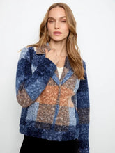 Load image into Gallery viewer, A woman modeling a boucle plaid short coat with blue, beige, and orange sections, worn over a white top and black pants against a plain white background.
