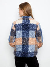 Load image into Gallery viewer, A woman shown from the back wearing a   boucle plaid short coat with blue, beige, and orange sections, and black pants against a plain white background.
