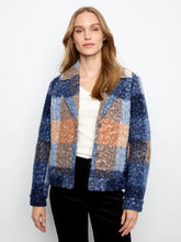 Load image into Gallery viewer, A woman modeling a boucle plaid short coat with blue, beige, and orange sections, worn over a white top and black pants against a plain white background.

