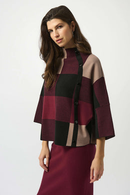 Woman wearing a burgundy, black and taupe patterned sweater and burgundy skirt against a white background.