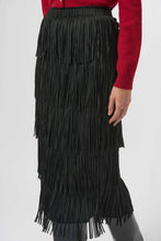 Load image into Gallery viewer, Close-up of model wearing a tiered fringe black long skirt and red cardigan against a light background.
