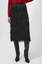 Load image into Gallery viewer, Model wearing a tiered fringe black long skirt, red cardigan and tall black boots against a light background.
