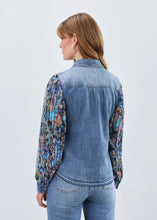 Load image into Gallery viewer, Woman in denim shacket with floral sleeves and jeans against a white background.
