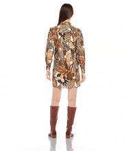 Load image into Gallery viewer, This shirtdress, expertly crafted from premium French cotton, showcases a striking safari floral print. The design is elevated by blouson sleeves and elegant gold buttons. Incorporate a piece of French style into your wardrobe with this sophisticated and stylish dress.
